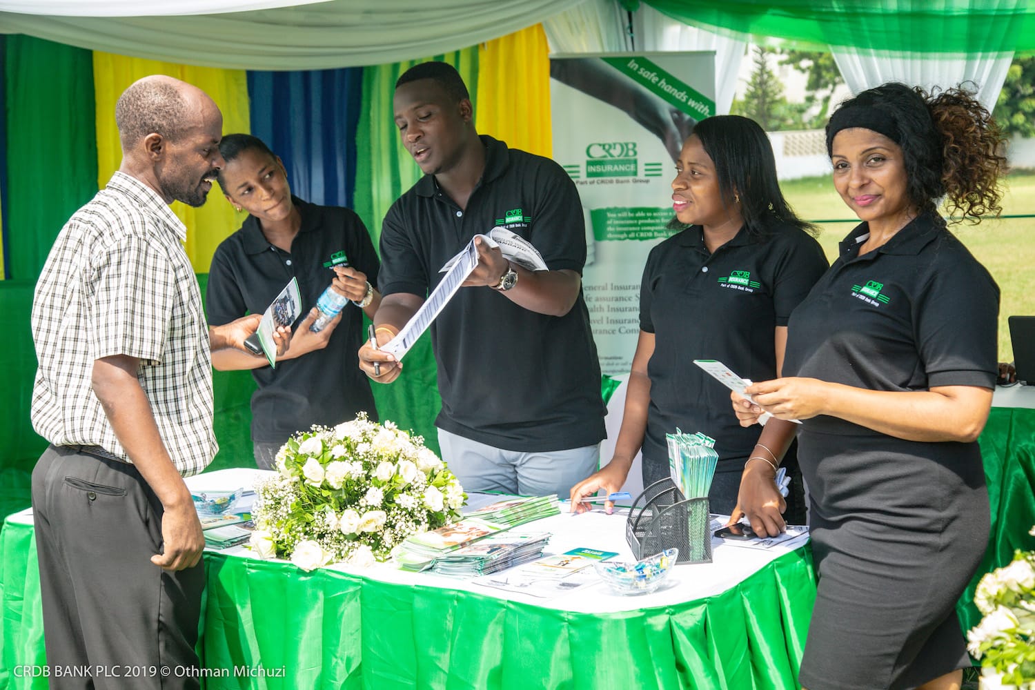 Team meeting with clients at green branded table